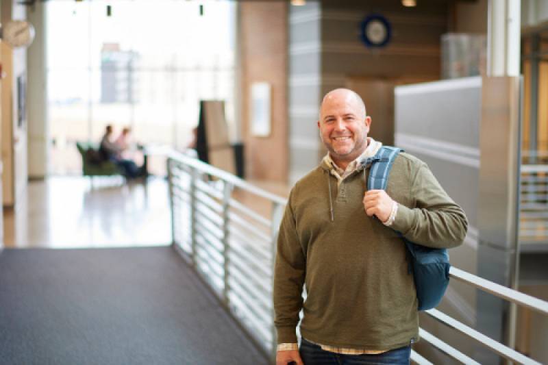an adult student on his way to work